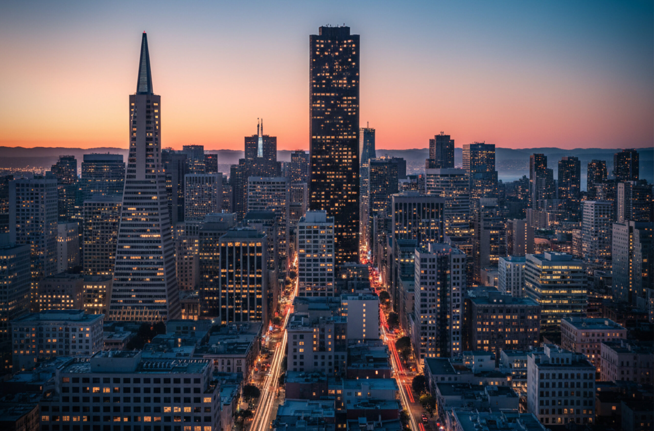 San Francisco skyline at dusk with the Transamerica Pyramid and city lights.