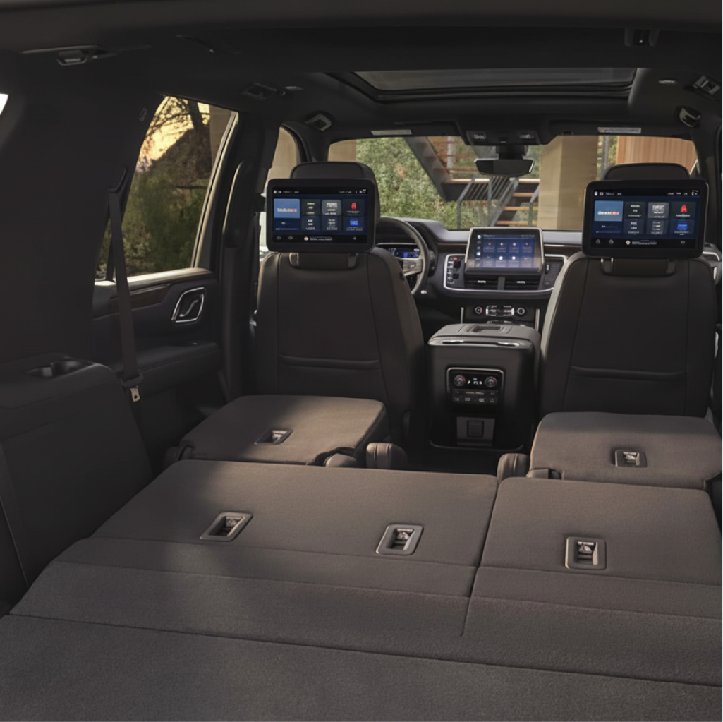 Interior of a large SUV showing seats folded flat and dual headrest screens, highlighting roomy cargo space for NJ private airport transfer service.