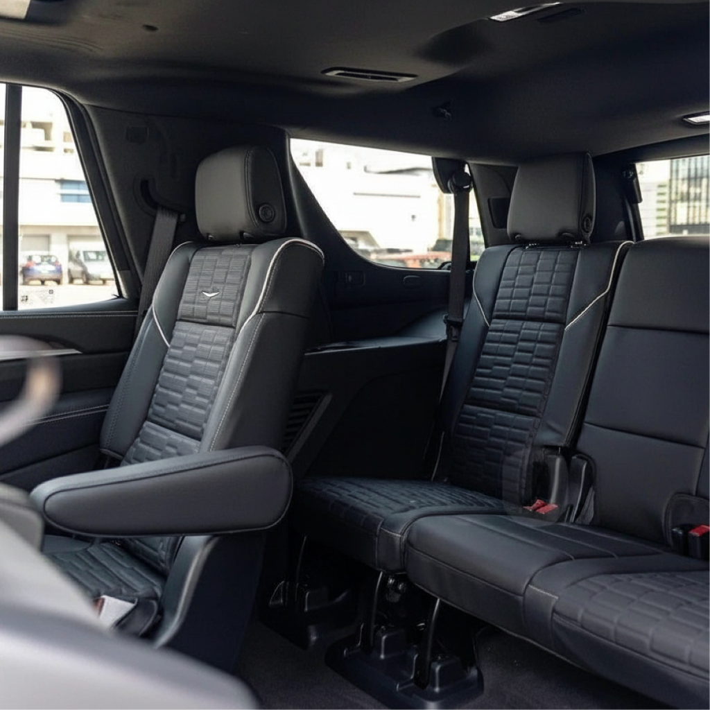Interior of a New Jersey chauffeur-driven 3-row SUV showing a leather captain’s chair and third-row bench for airport transfer and private car service.
